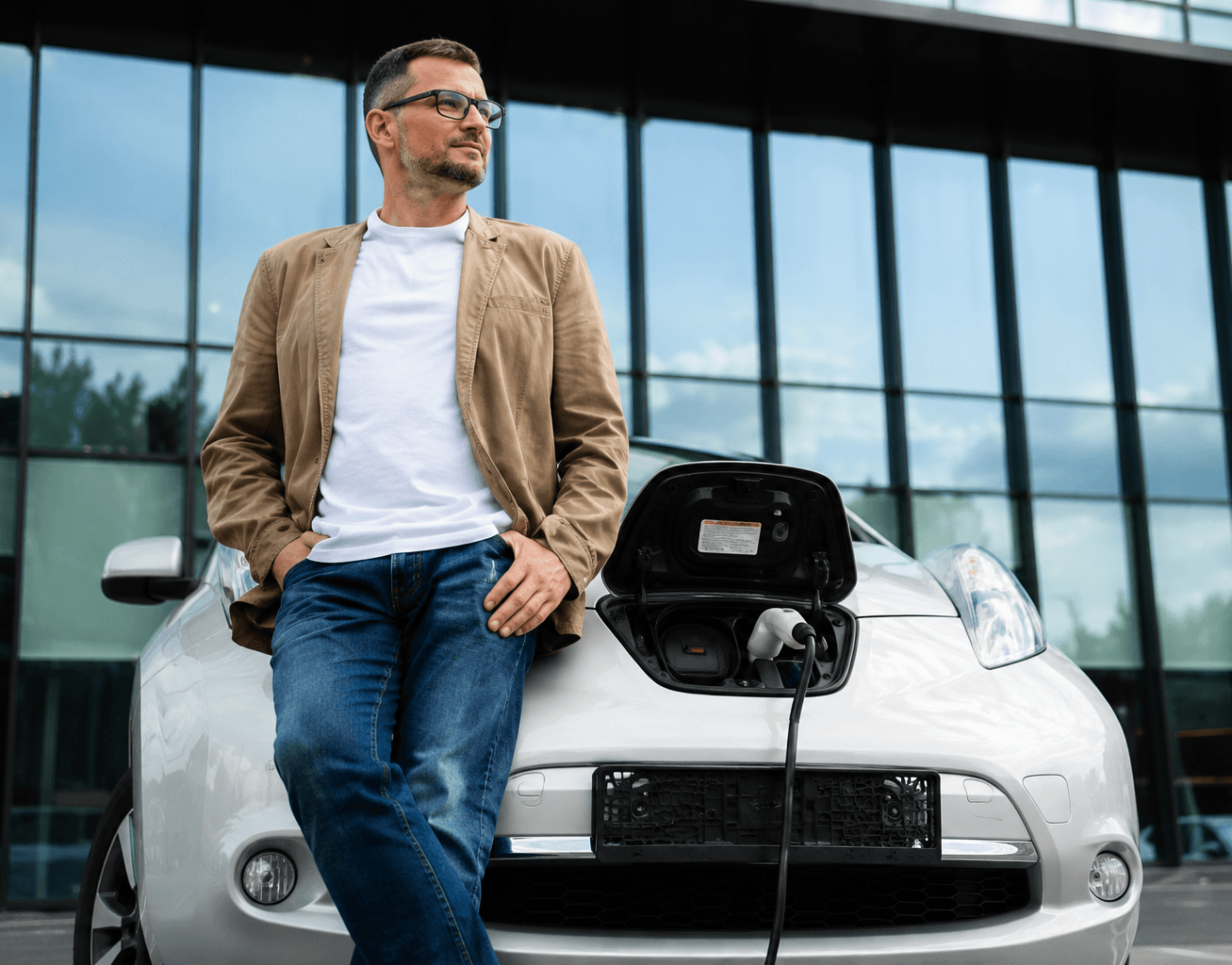 A driver checking a phone beside a charging bay